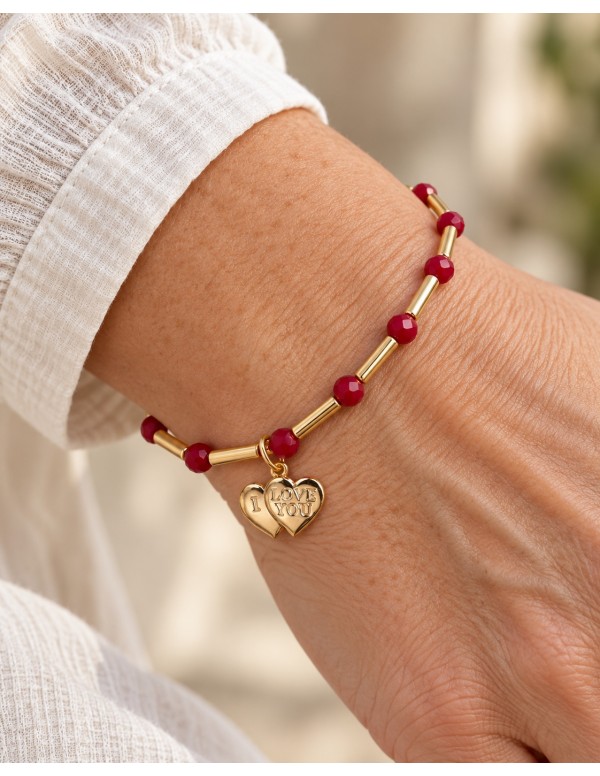 Pulsera roja con doble corazón I Love You bañada en oro puesta en la muñeca