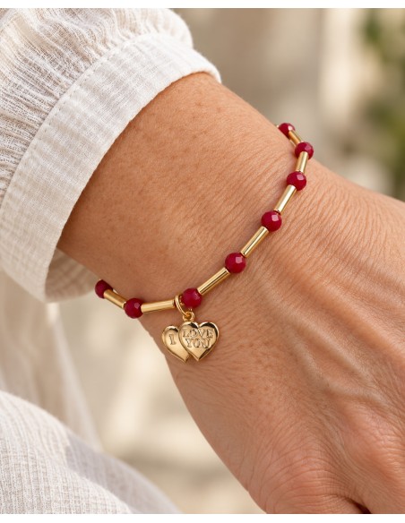 Pulsera roja con doble corazón I Love You bañada en oro puesta en la muñeca
